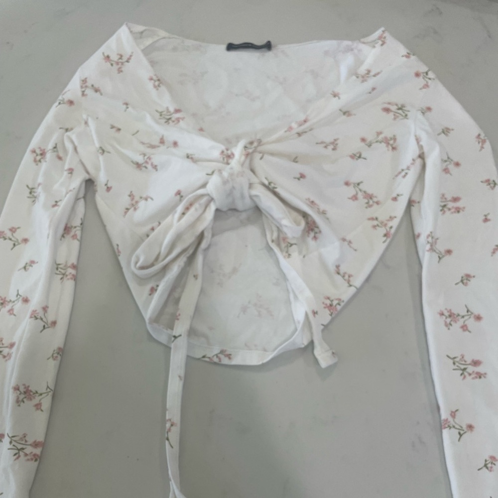 White brandy wrap top with pink flowers.